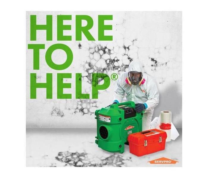 SERVPRO tech in white PPE suit with an air scrubber.